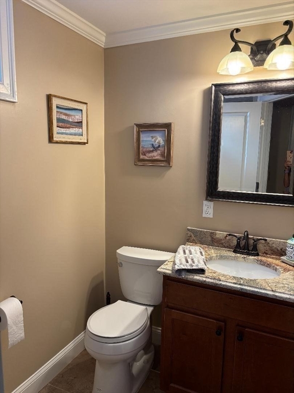 9 Endicott Street, Unit B Danvers, MA 01923 - Photo 30 of 42 a bathroom with a toilet sink and mirror