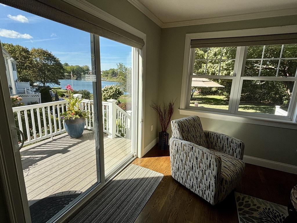9 Endicott Street, Unit B Danvers, MA 01923 - Photo 3 of 42 a balcony with furniture and wooden floor