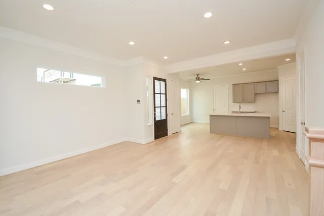 a view of a big room with wooden cabinet and windows