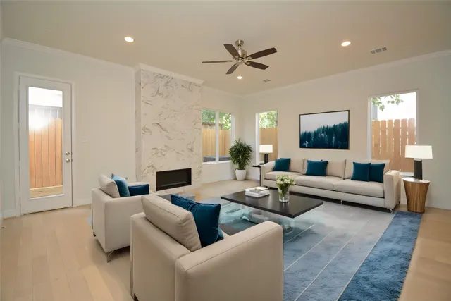 a living room with fireplace furniture and a rug
