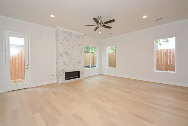 a view of a livingroom with a fireplace and window