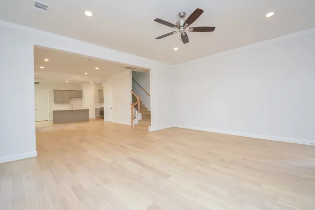 an empty room with a empty space and a ceiling fan