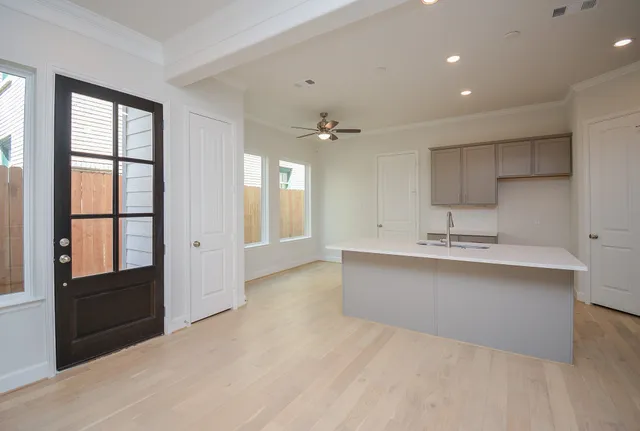 a view of living room kitchen with stainless steel appliances granite countertop furniture and a fireplace