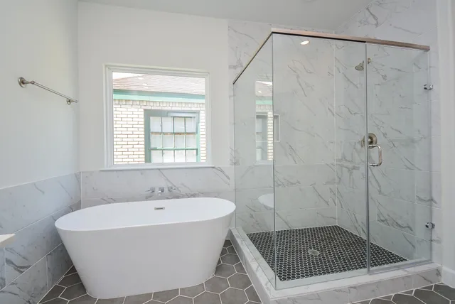 a bathroom with a bathtub and shower