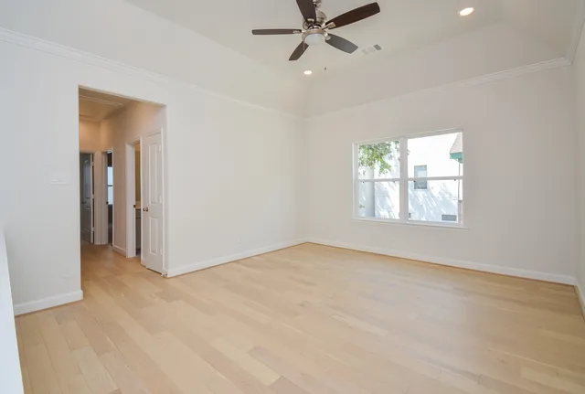 an empty room with windows and closet