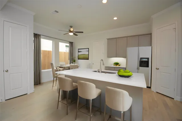 a kitchen with a sink cabinets and wooden floor