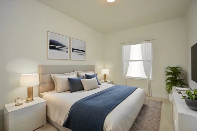 a bedroom with a bed and a potted plant