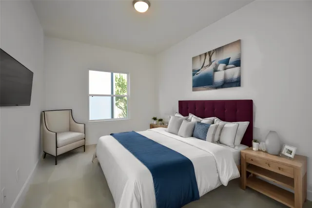 a bedroom with a bed and a couch