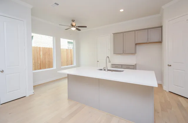 a kitchen with a sink cabinets and window