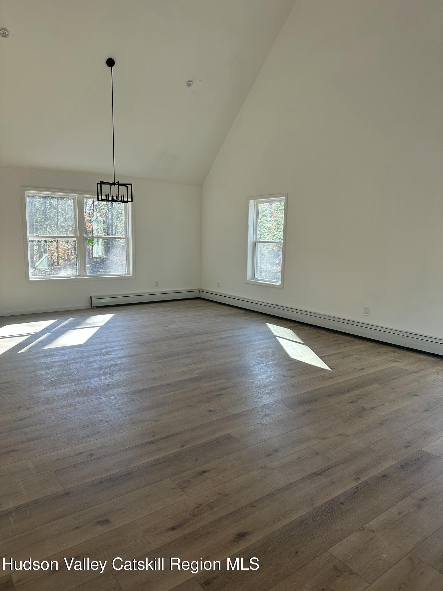 20 Olivers Way Cairo, NY 12413 - Photo 13 of 15 an empty room with wooden floor and windows