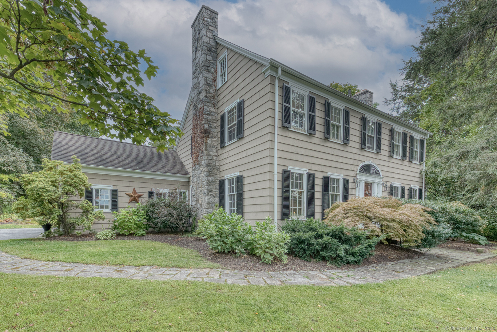 a front view of house with yard and green space