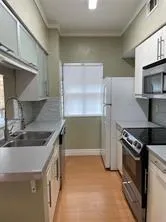 a kitchen that has a sink and a stove