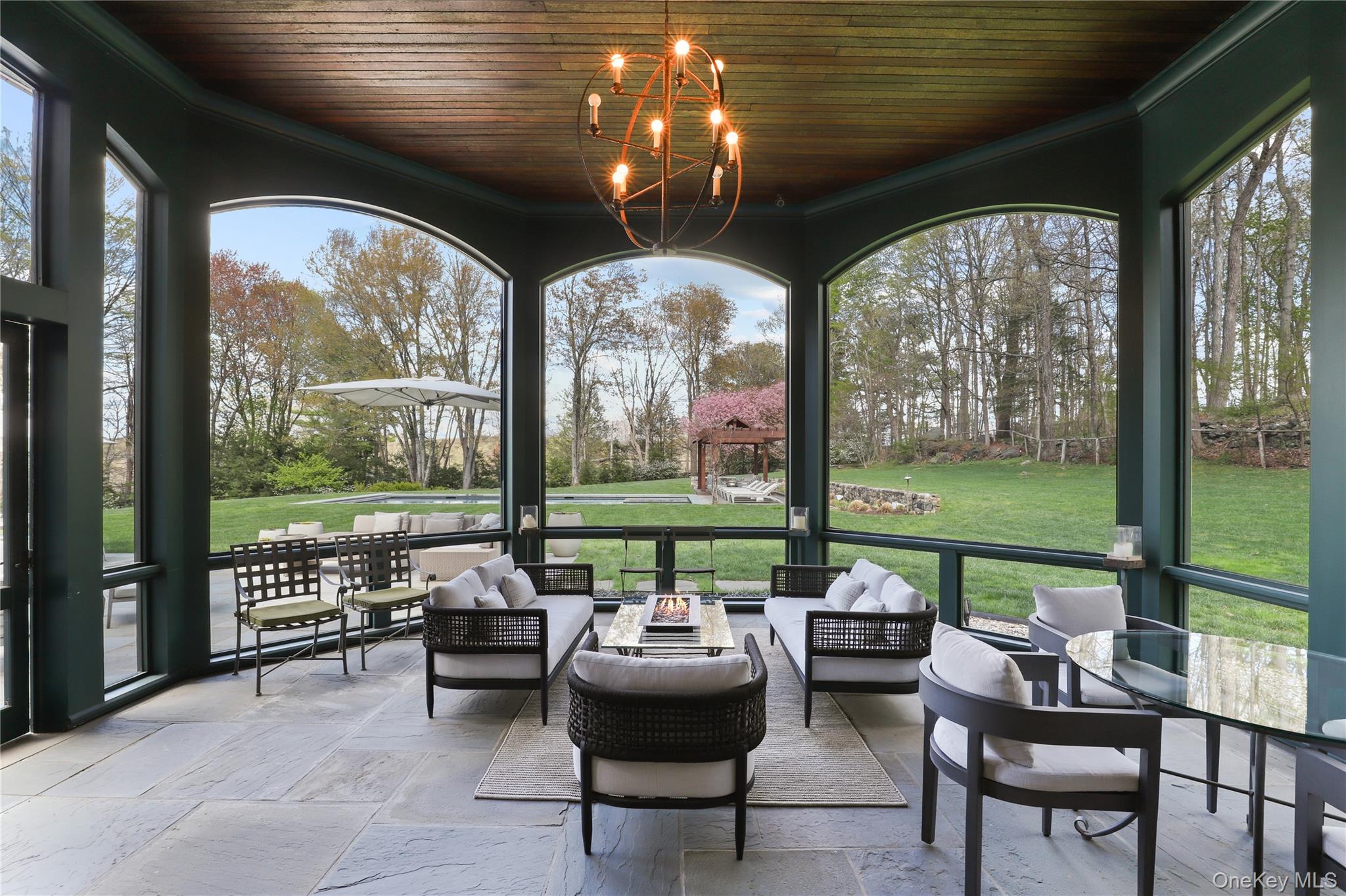 10 Upland Road North Bedford, NY 10506 - Photo 3 of 36 a living room with patio furniture and a floor to ceiling window