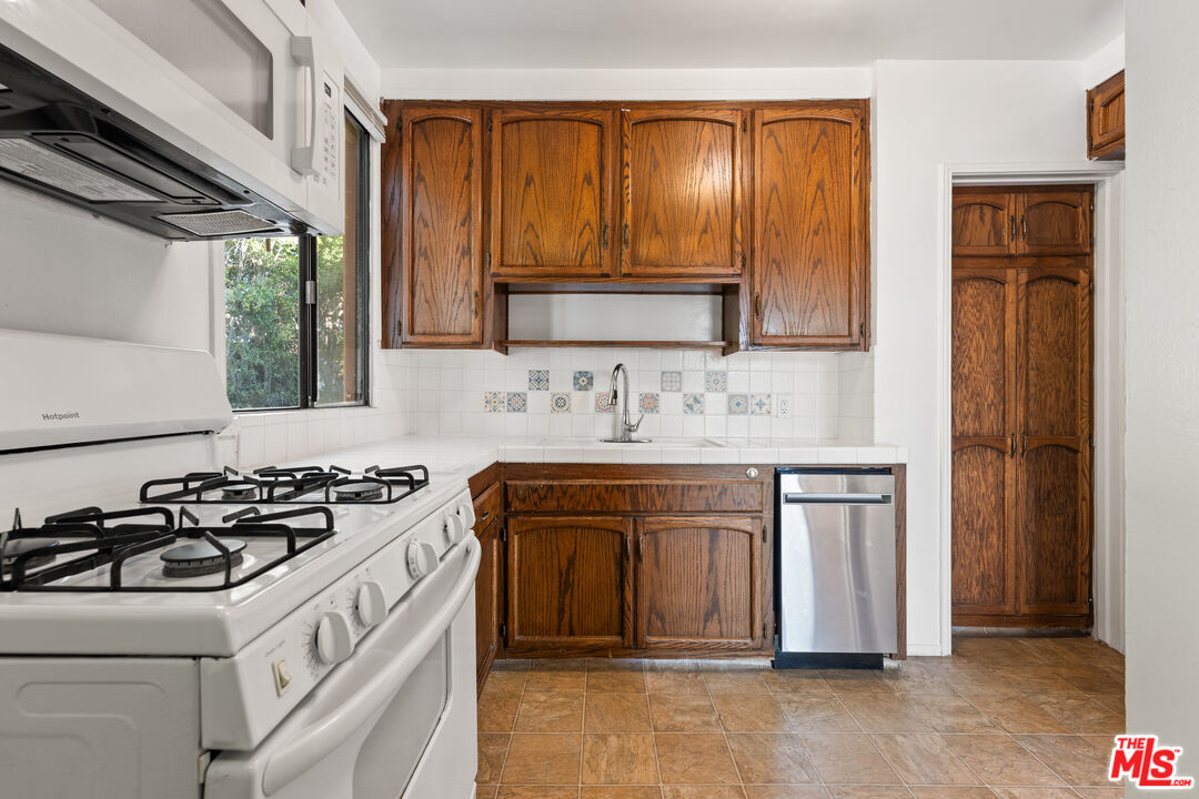 8710 El Manor Avenue, Unit 1 Los Angeles, CA 90045 - Photo 2 of 12 a kitchen with stainless steel appliances granite countertop a sink stove and refrigerator
