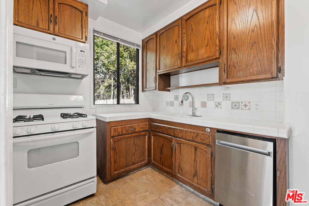 8710 El Manor Avenue, Unit 1 Los Angeles, CA 90045 - Photo 3 of 12 a kitchen with appliances cabinets and a sink