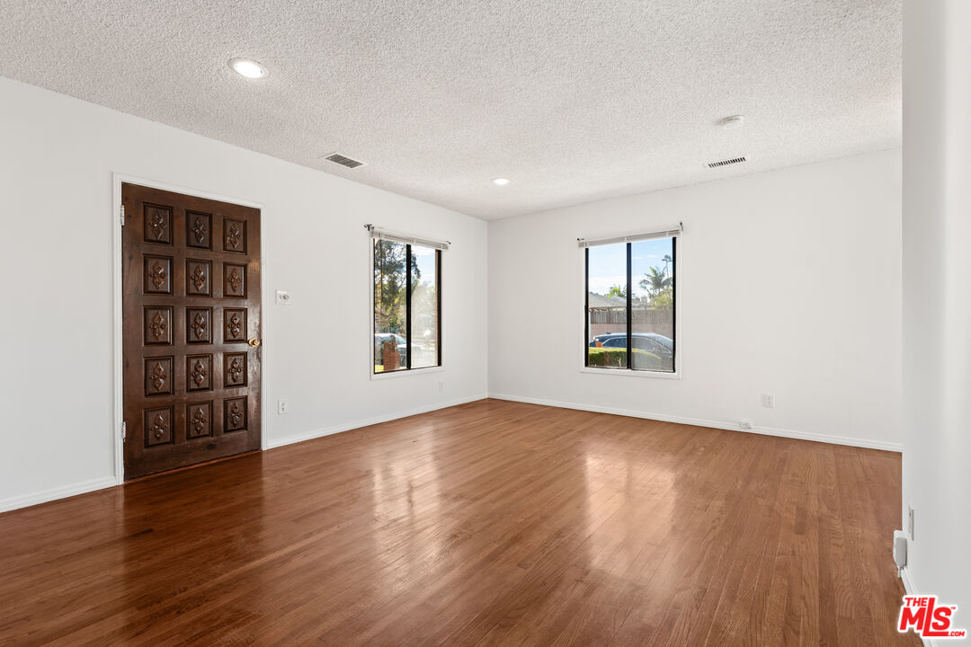 8710 El Manor Avenue, Unit 1 Los Angeles, CA 90045 - Photo 6 of 12 a view of an empty room with wooden floor and a window