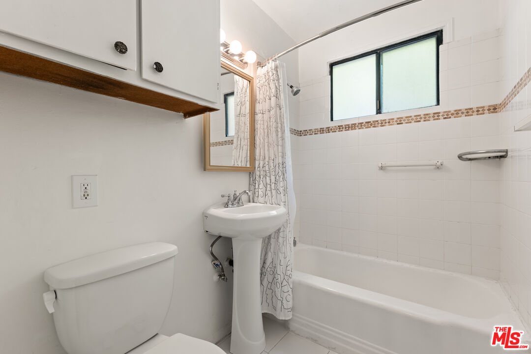 8710 El Manor Avenue, Unit 1 Los Angeles, CA 90045 - Photo 8 of 12 a bathroom with a sink a toilet and shower
