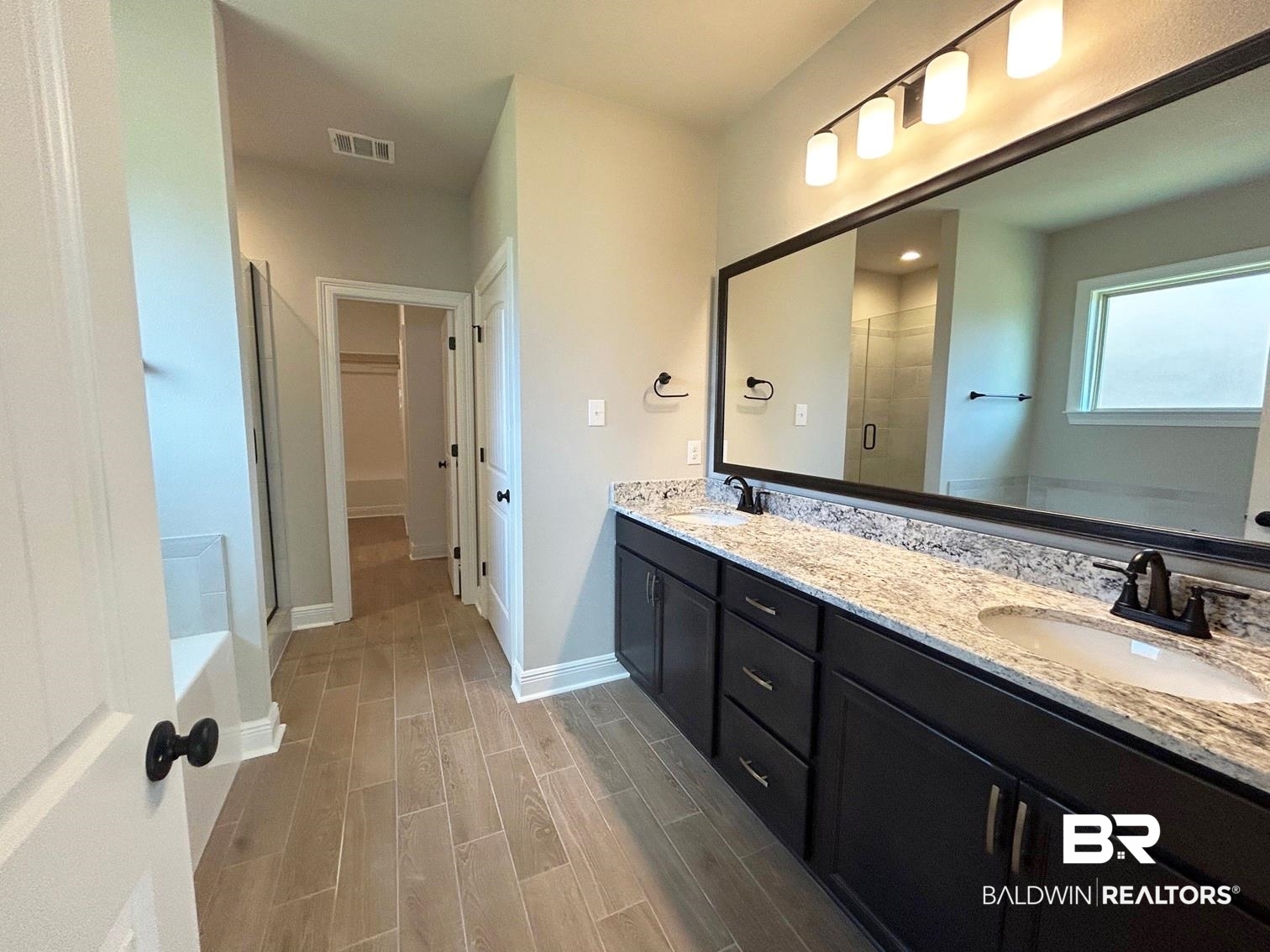 848 Sumter Loop Foley, AL 36535 - Photo 7 of 16 Bathroom with vanity, wood-type flooring, and a shower with shower door