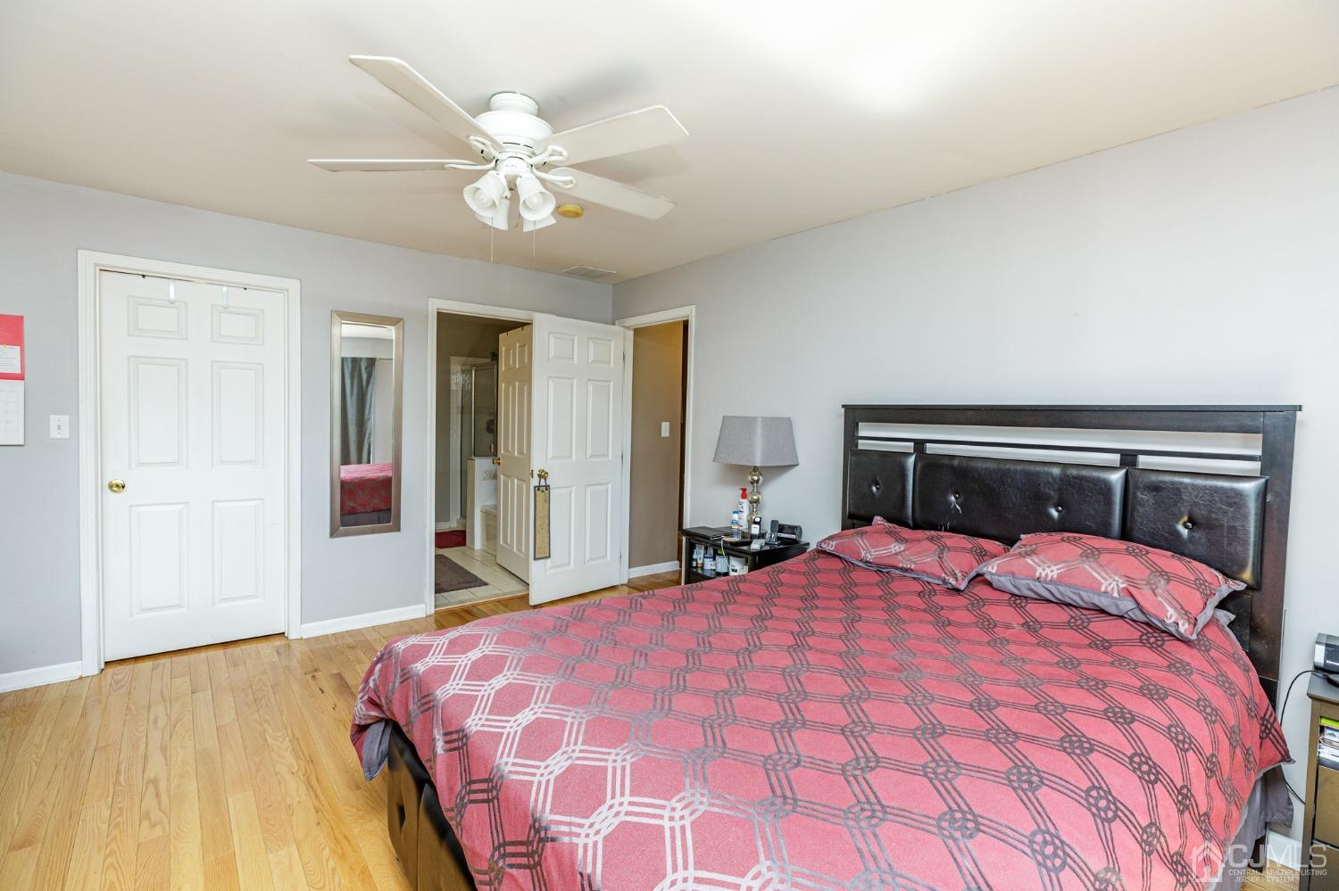 307 Lilac Drive Union, NJ 07083 - Photo 12 of 25 a bedroom with a large bed and a chandelier
