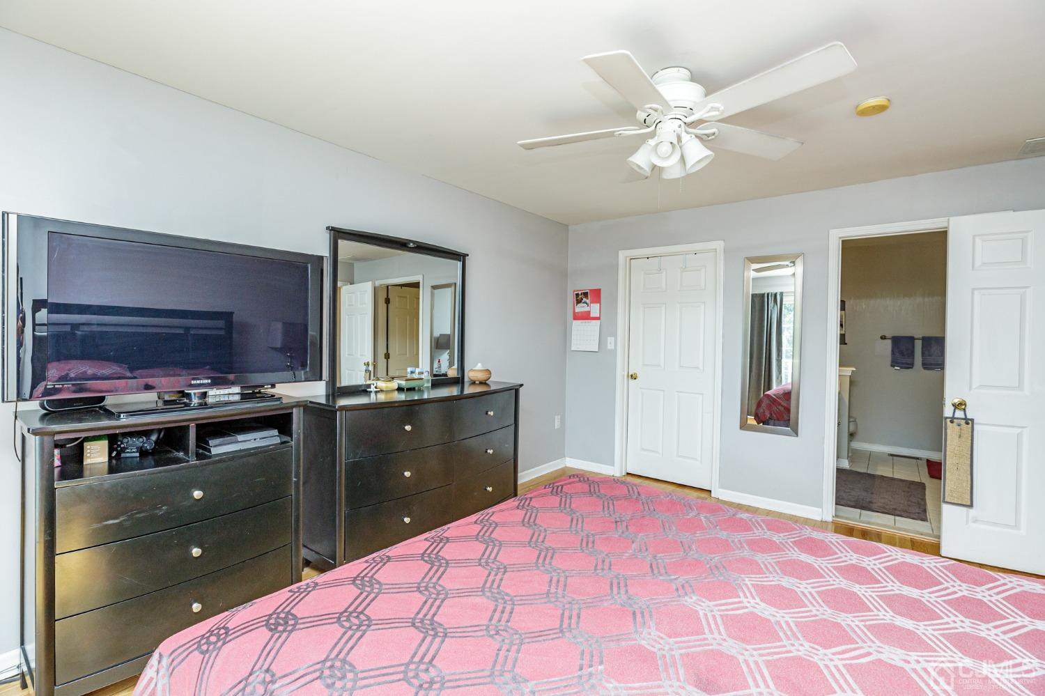 307 Lilac Drive Union, NJ 07083 - Photo 14 of 25 a bedroom with a bed and a chandelier