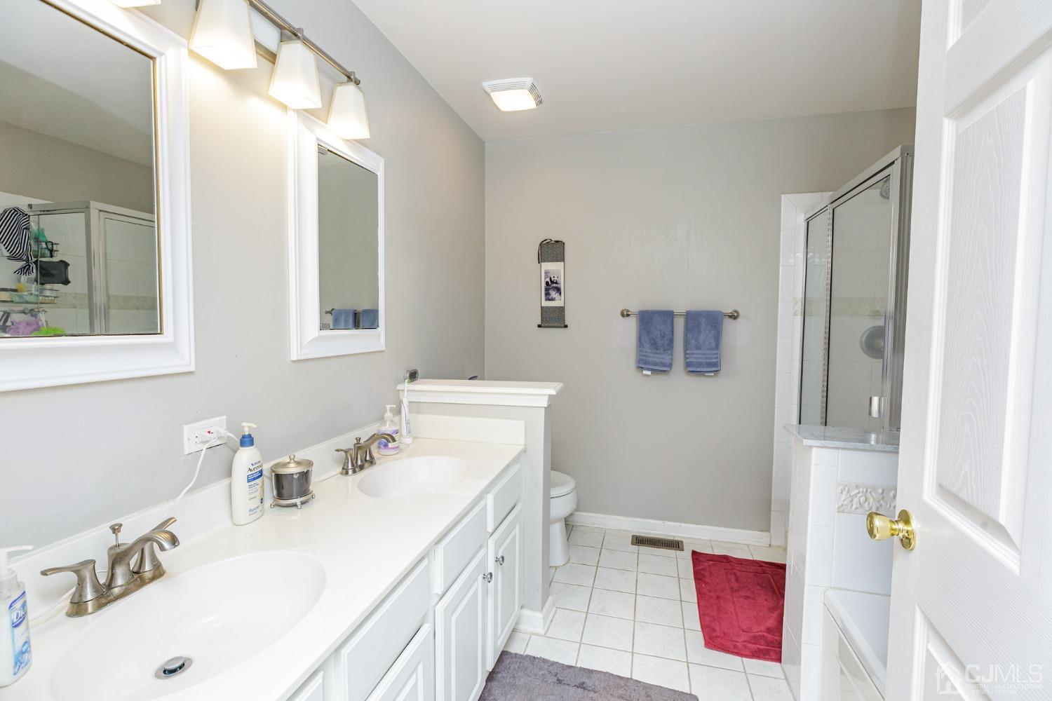 307 Lilac Drive Union, NJ 07083 - Photo 16 of 25 a bathroom with a tub sink and mirror