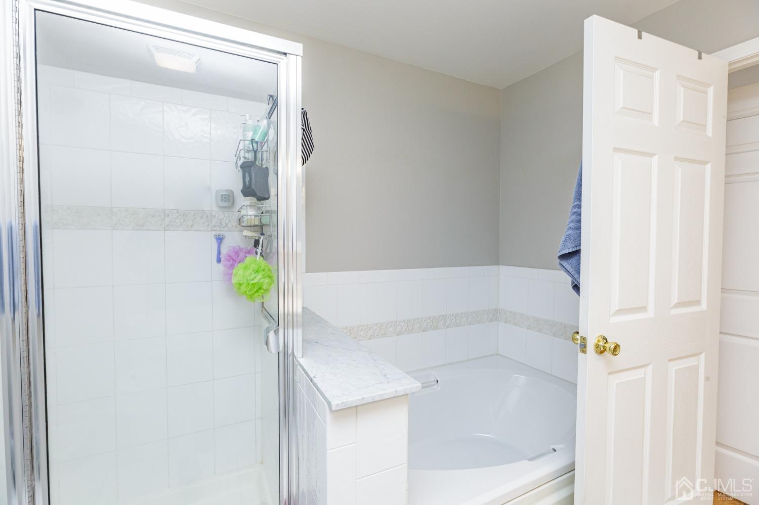307 Lilac Drive Union, NJ 07083 - Photo 17 of 25 a bathroom with a tub and shower