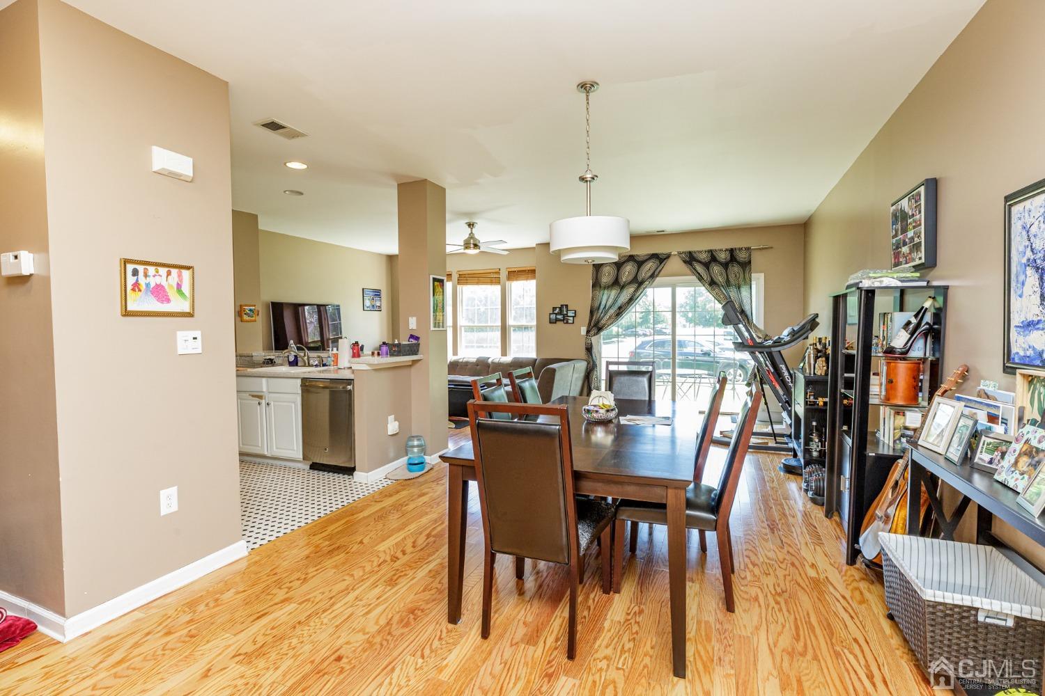 307 Lilac Drive Union, NJ 07083 - Photo 10 of 25 a view of a dining room and livingroom with furniture wooden floor kitchen view and a window