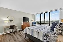 a bedroom with a bed and a flat screen tv