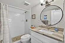 a bathroom with a sink a toilet and a mirror