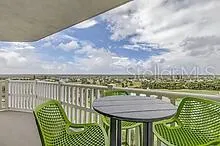 a view of a balcony with two chairs and a table