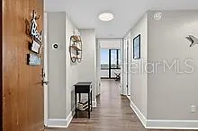 a view of a hallway with wooden floor and entryway
