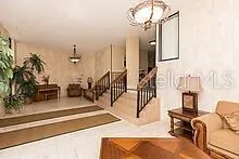 a view of a livingroom with furniture and staircase