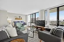 a living room with furniture and a large window