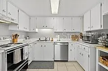 a kitchen with granite countertop cabinets stainless steel appliances and a sink