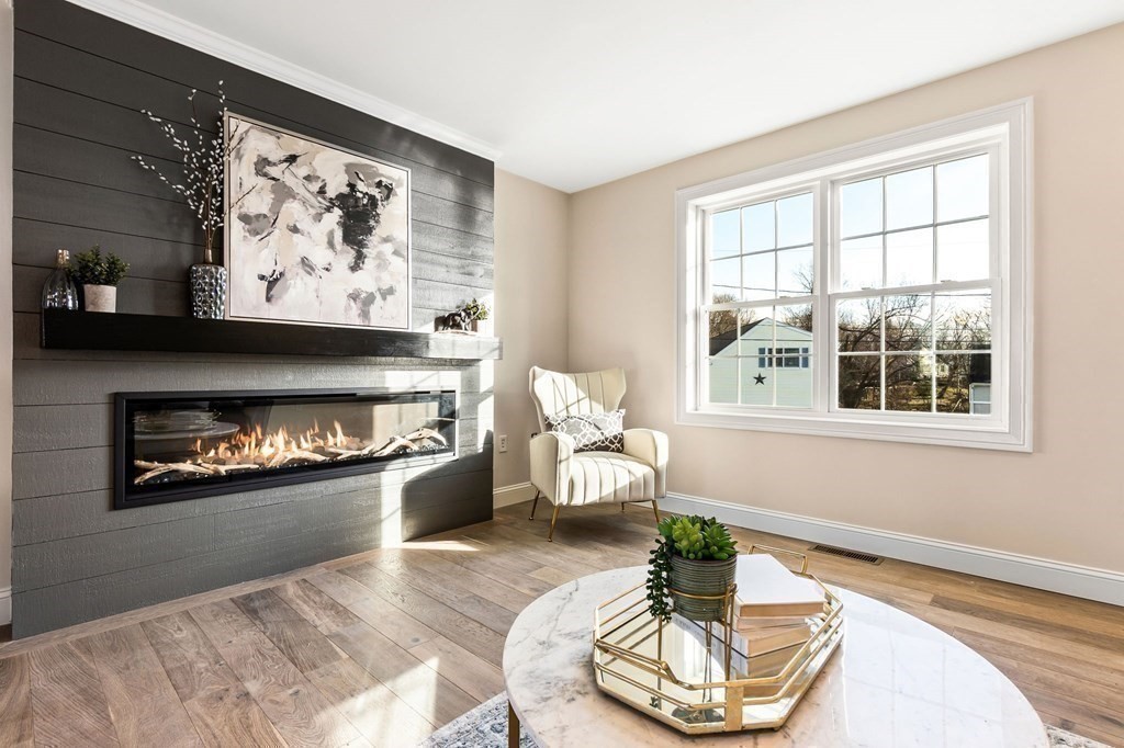 59 Riverview Avenue Danvers, MA 01923 - Photo 11 of 30 a living room with furniture and a fireplace