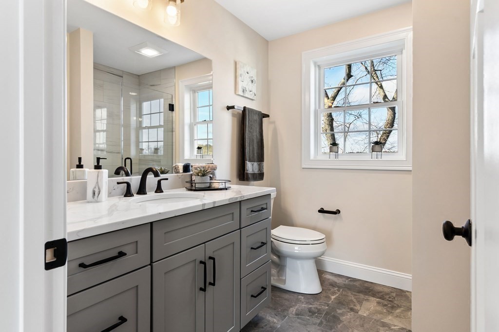 59 Riverview Avenue Danvers, MA 01923 - Photo 15 of 30 a bathroom with a double vanity sink toilet and a mirror