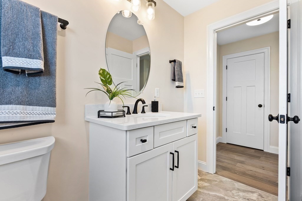 59 Riverview Avenue Danvers, MA 01923 - Photo 18 of 30 a bathroom with a sink a mirror and a toilet