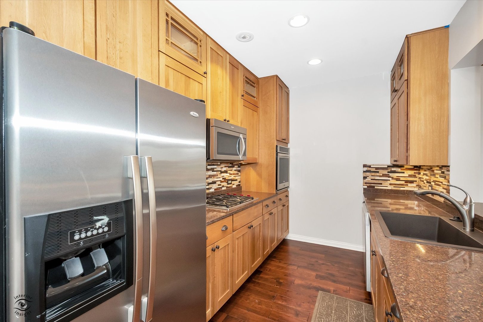 1414 North Wells Street, Unit 508 Chicago, IL 60610 - Photo 13 of 28 a kitchen with stainless steel appliances granite countertop a refrigerator and a stove