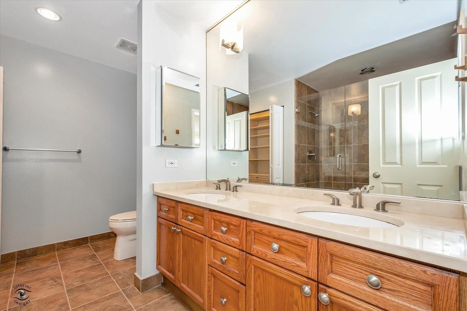 1414 North Wells Street, Unit 508 Chicago, IL 60610 - Photo 19 of 28 a bathroom with a granite countertop double vanity sink a mirror and a toilet