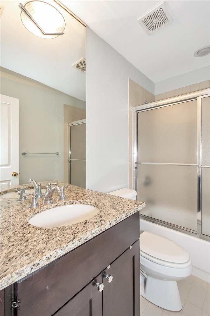 1414 North Wells Street, Unit 508 Chicago, IL 60610 - Photo 24 of 28 a bathroom with a granite countertop sink toilet and shower