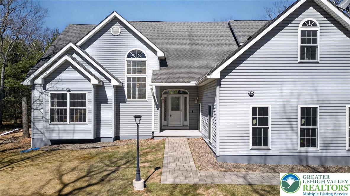 162 Oak Ridge Drive Milford, PA 18337 - Photo 1 of 45 a view of a house with wooden fence and large windows