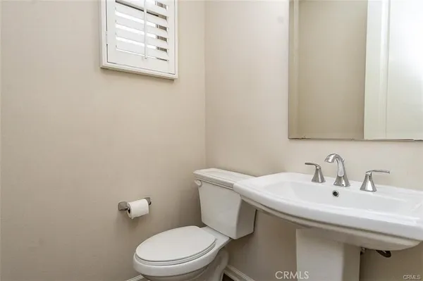 a white toilet sitting next to a white sink