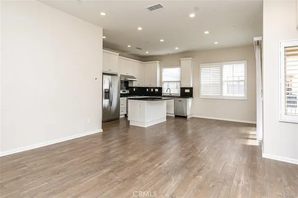 a kitchen with stainless steel appliances granite countertop a stove and a refrigerator