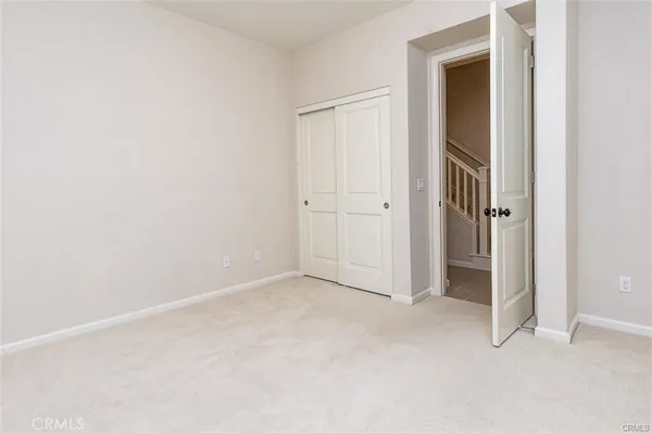 an empty room with closet area
