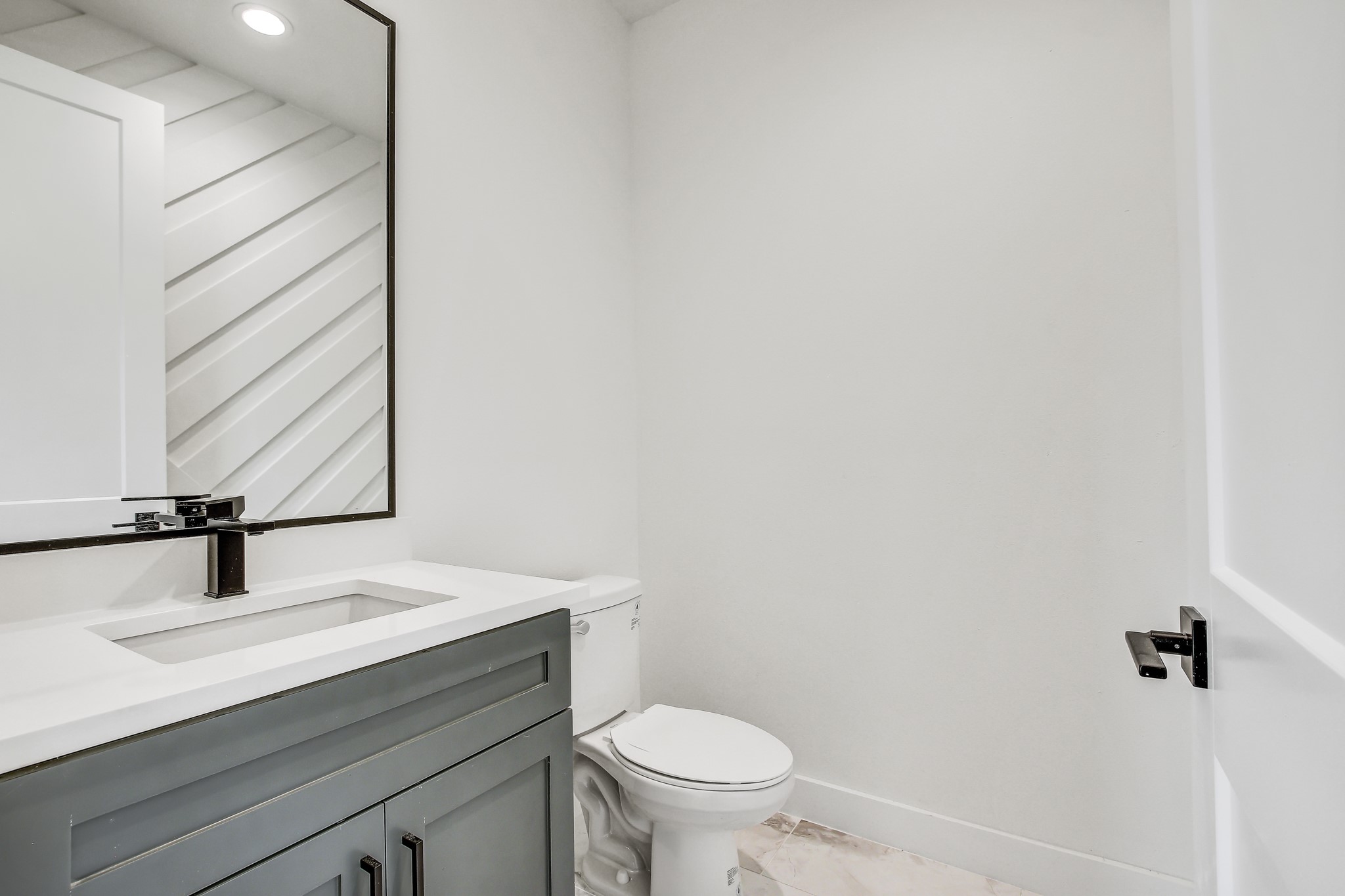 4127 East 12th Street, Unit 3 Austin, TX 78721 - Photo 11 of 29 Half bath featuring toilet, vanity, baseboards, and recessed lighting