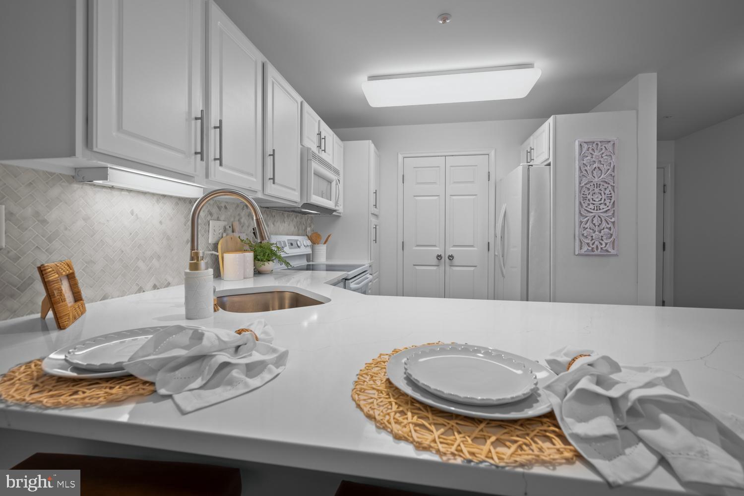 2011 Rudy Serra Drive, Unit 1C Eldersburg, MD 21784 - Photo 11 of 36 a kitchen with a sink a stove and cabinets