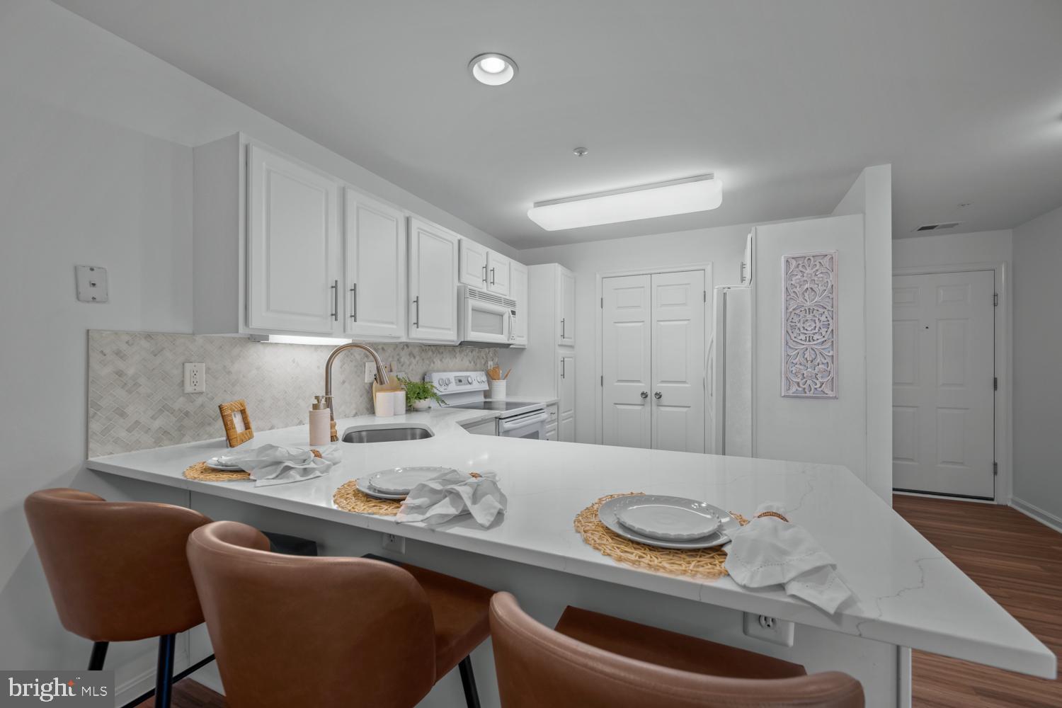 2011 Rudy Serra Drive, Unit 1C Eldersburg, MD 21784 - Photo 14 of 36 a kitchen with stainless steel appliances granite countertop a table and chairs