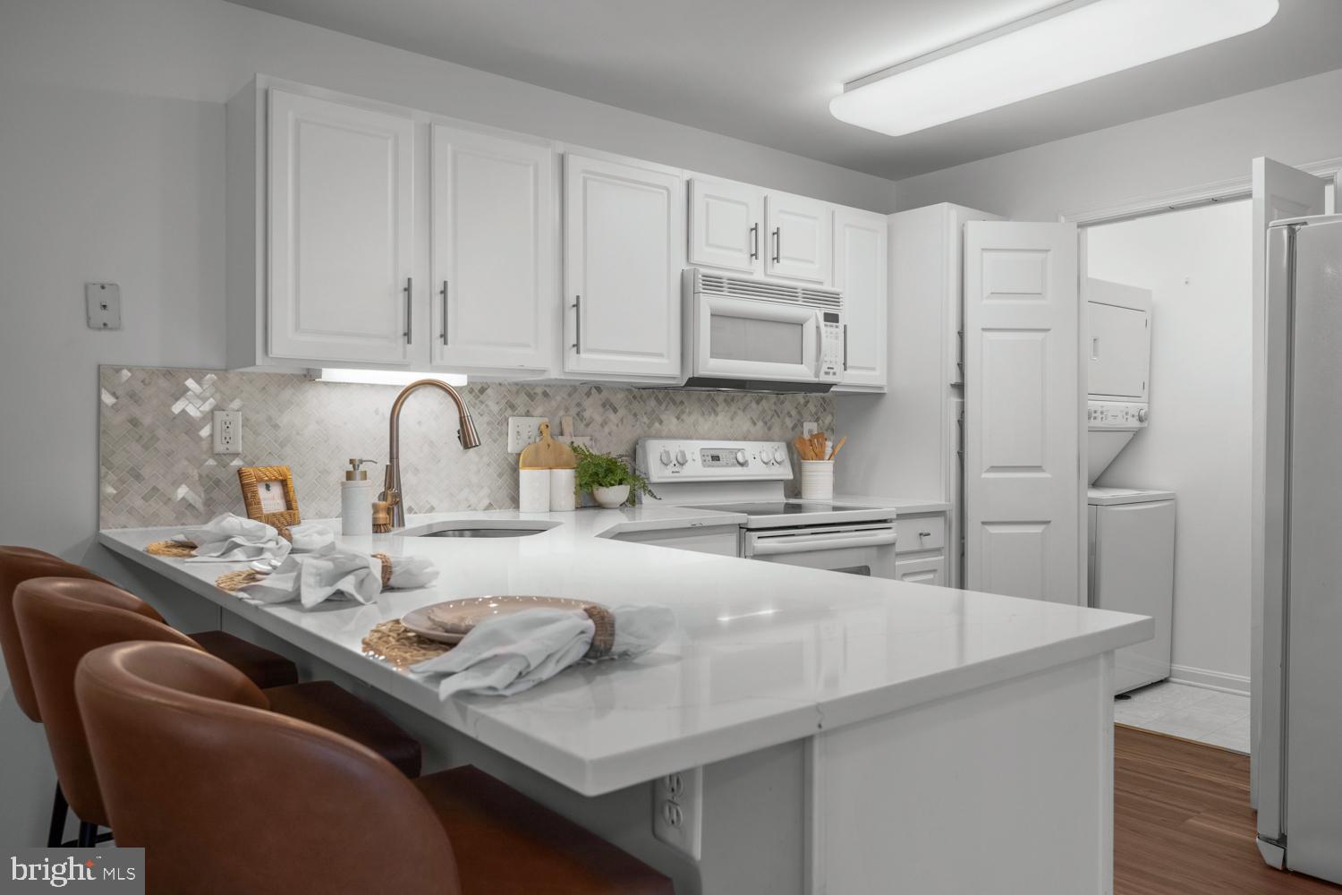 2011 Rudy Serra Drive, Unit 1C Eldersburg, MD 21784 - Photo 16 of 36 a kitchen with stainless steel appliances granite countertop a sink a stove and a refrigerator
