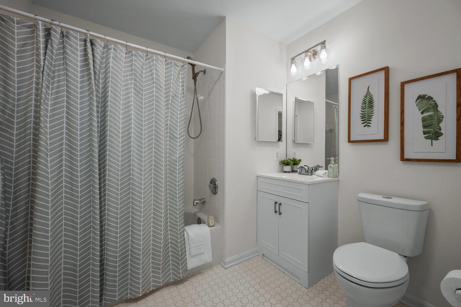 2011 Rudy Serra Drive, Unit 1C Eldersburg, MD 21784 - Photo 22 of 36 a bathroom with a shower a sink mirror and toilet