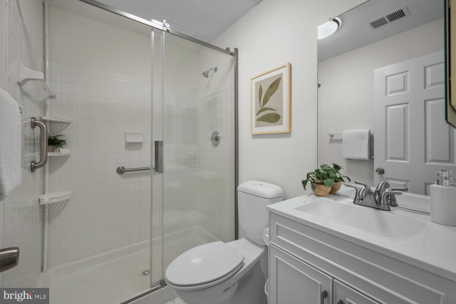 2011 Rudy Serra Drive, Unit 1C Eldersburg, MD 21784 - Photo 25 of 36 a bathroom with a sink a toilet and shower